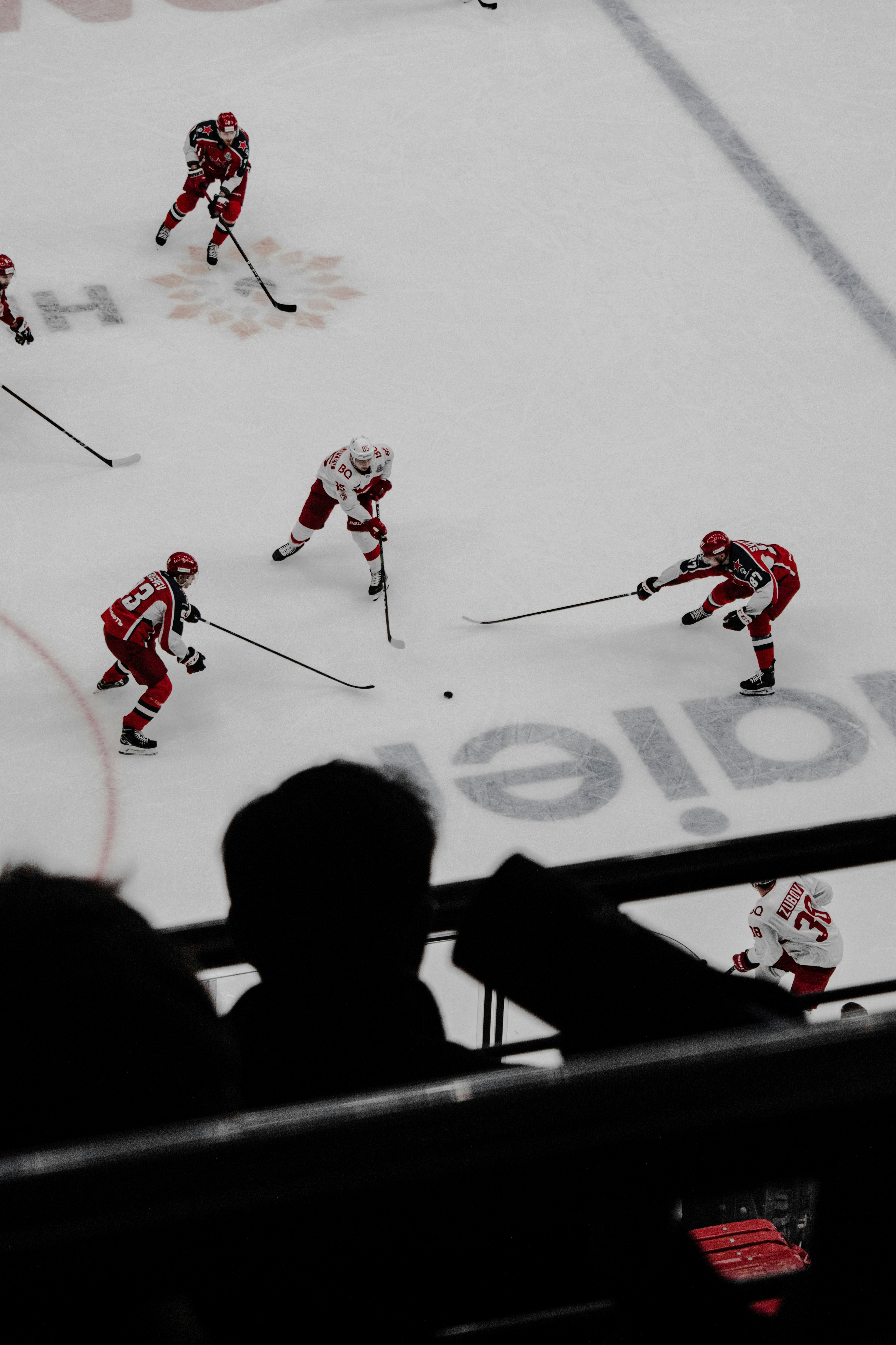 people playing ice hockey during daytime